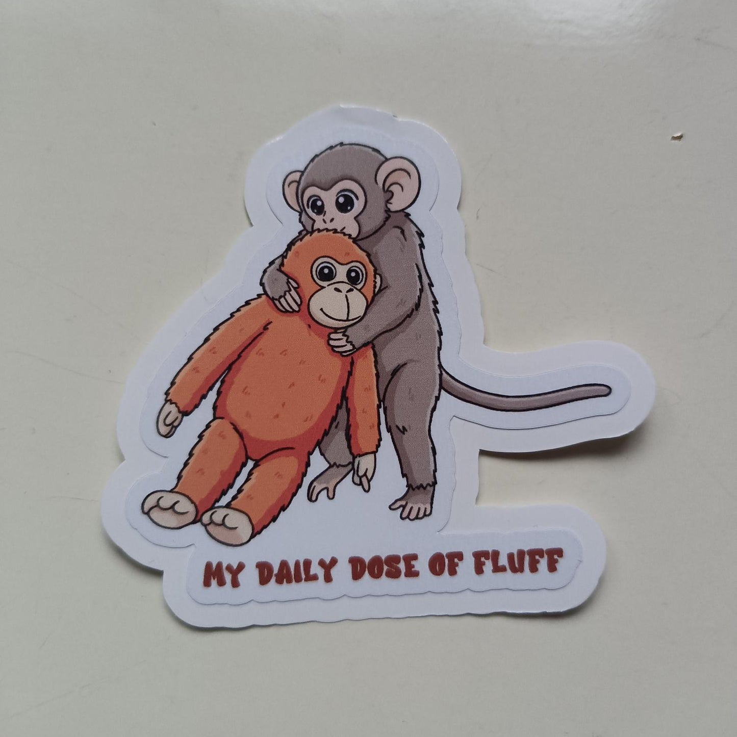 Pung-yo Punch Monkey Sticker - "My Daily Dose of Fluff" Viral Monkey and Plushie Decal - Cute Baby Monkey Holding Orange Toy